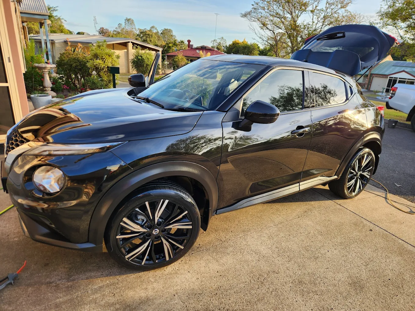 Glossy dark SUV with mirror finish exterior detailing