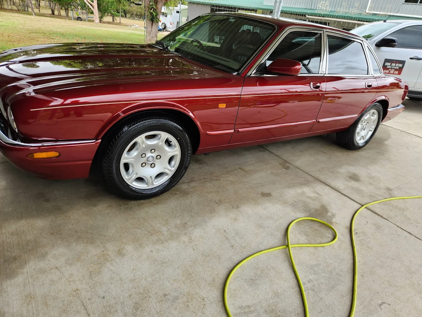 Classic burgundy sedan with professional exterior detailing