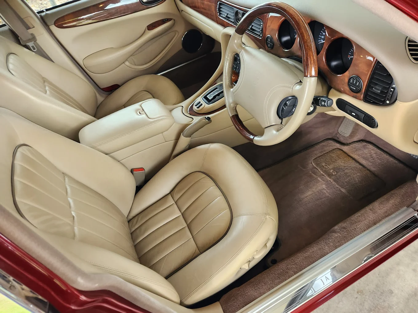 Luxury vehicle interior with wood grain and leather treatment